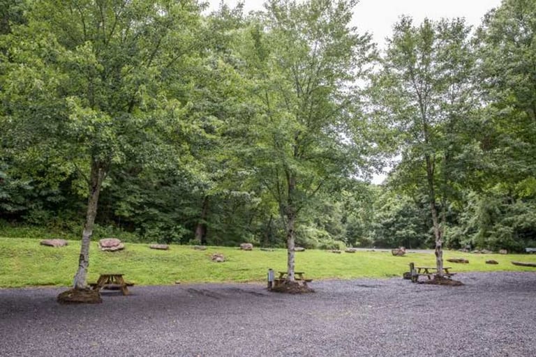 Shaded gravel partial hookup sites with picnic tables – Partial Hookup RV Site at The Outpost NRG