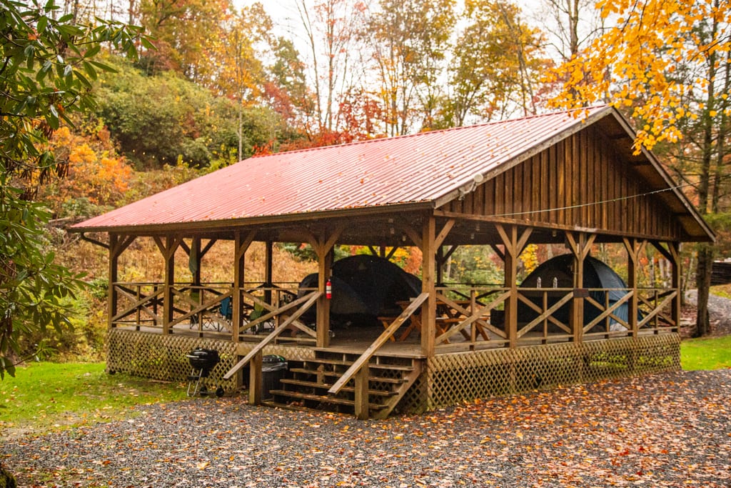 Covered tent pavilion with picnic table and fire pit – Tent Pavilion at The Outpost NRG