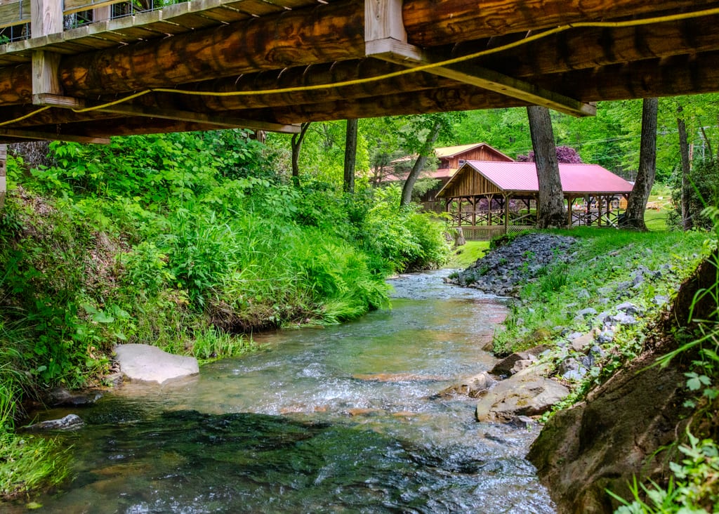 Creek-side view of the tent pavilion – Tent Pavilion at The Outpost NRG