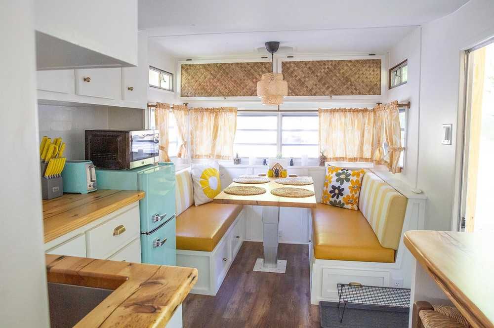 Mellow Yellow living and dining area with sunshine decor – Mellow Yellow Vintage Camper at The Outpost NRG